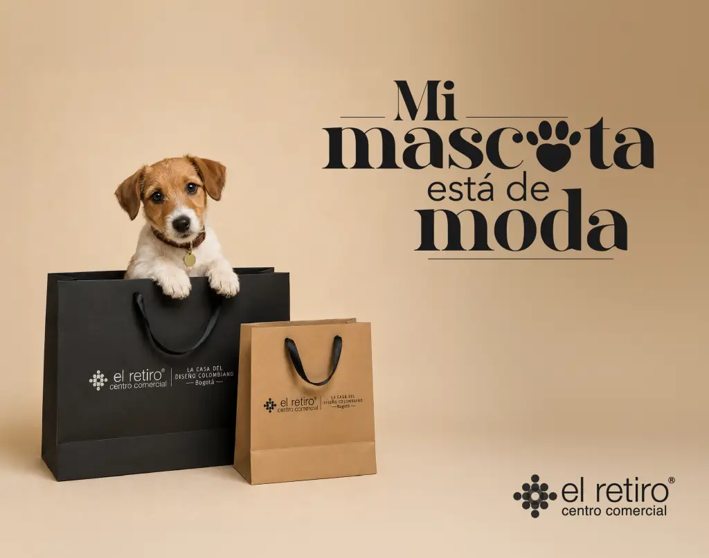 Perro pequeño asomando de una bolsa de compras negra, con dos bolsas marrones al frente y el logotipo de El Retiro Centro Comercial a la derecha.